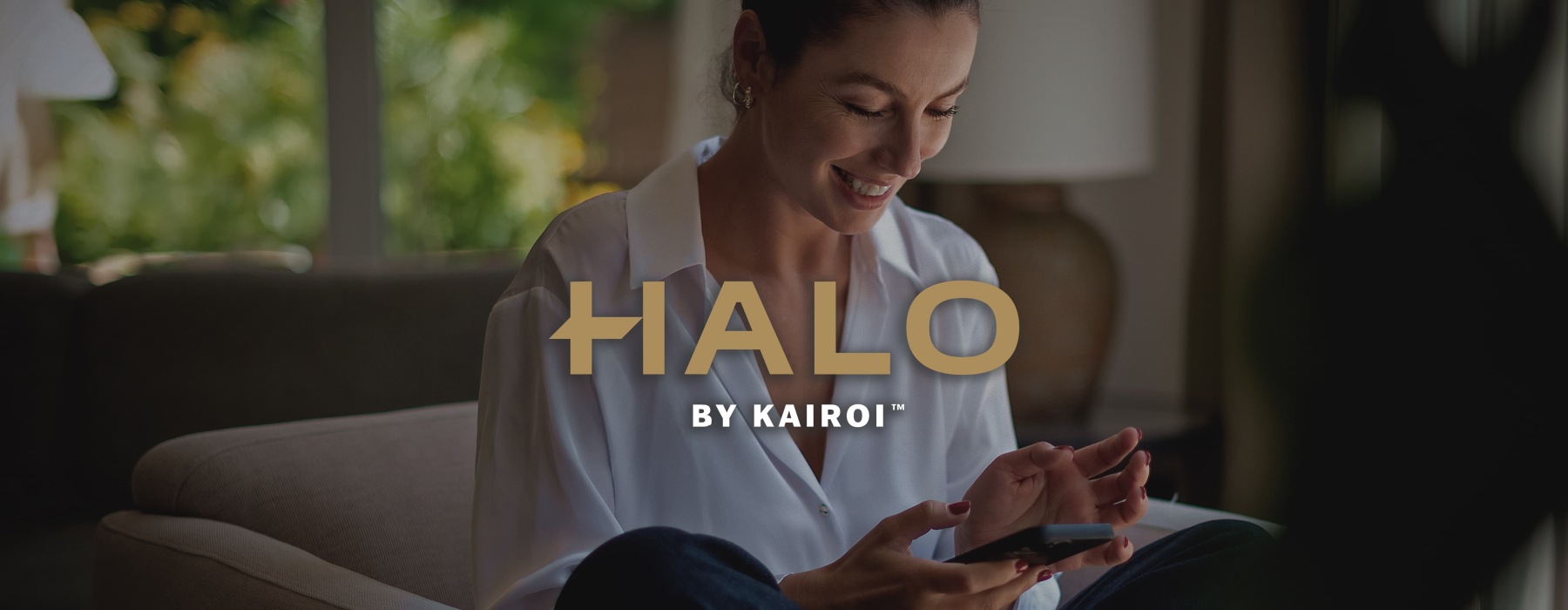 a woman smiling and interacting with her device